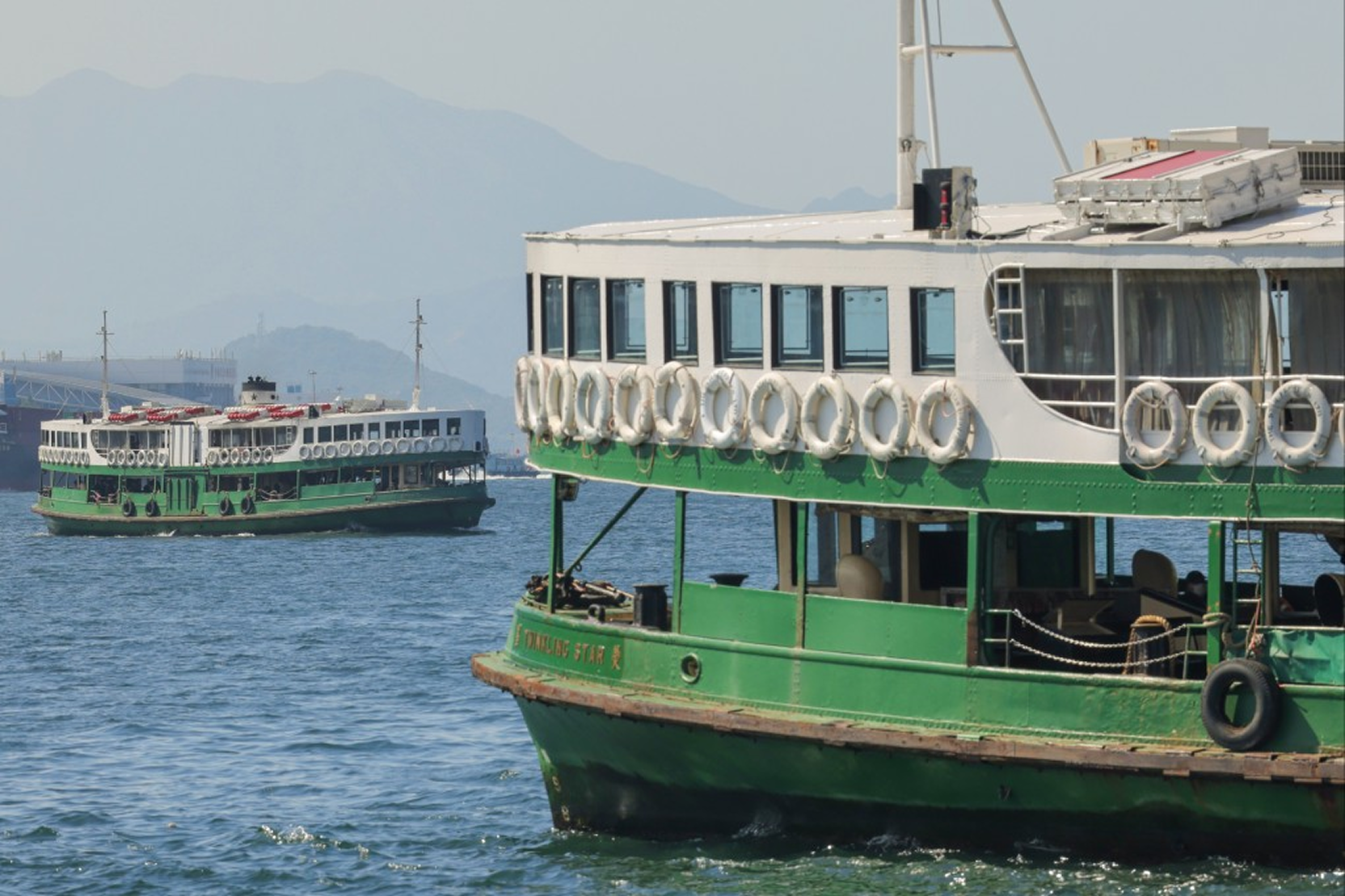 Green and white Star Ferry boats in Hong Kong harbor