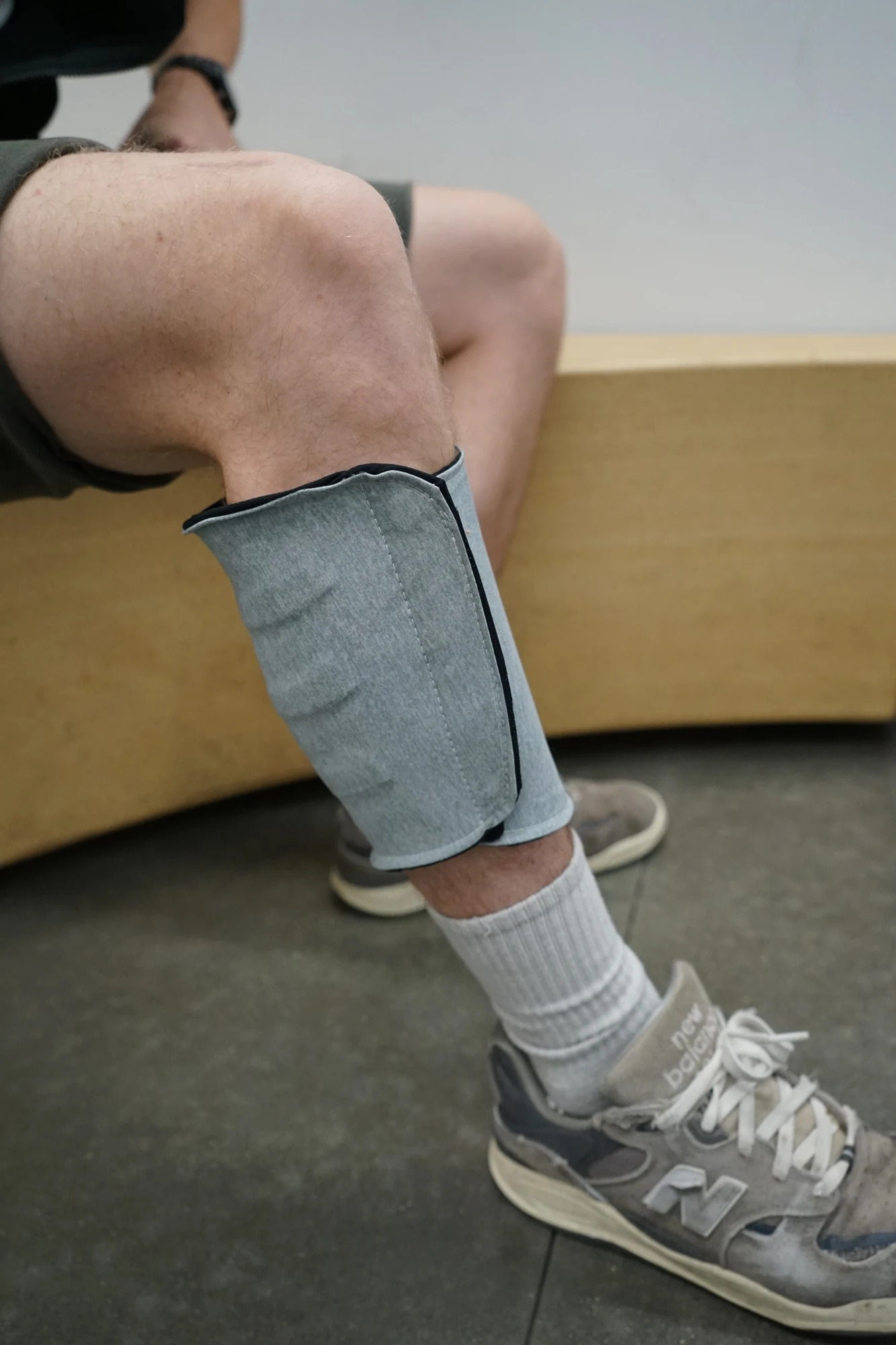 Close-up of the working compression sleeve wrapped around the calf indoors